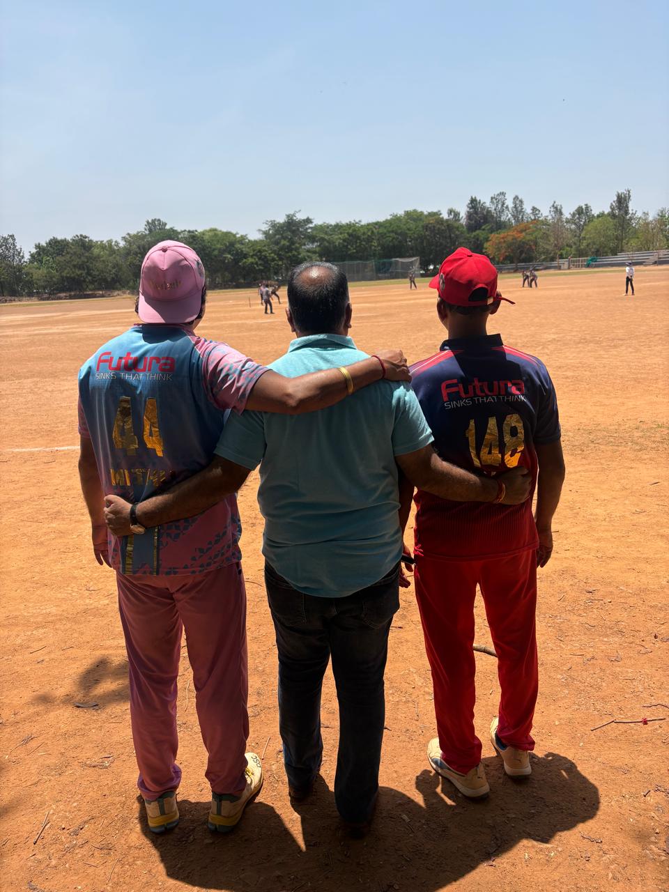 Futura Kitchen Sinks India Pvt Ltd sponsored players standing together at a Jain community cricket tournament organized by Siwanchi Jain Yuva Mandal in Bangalore.