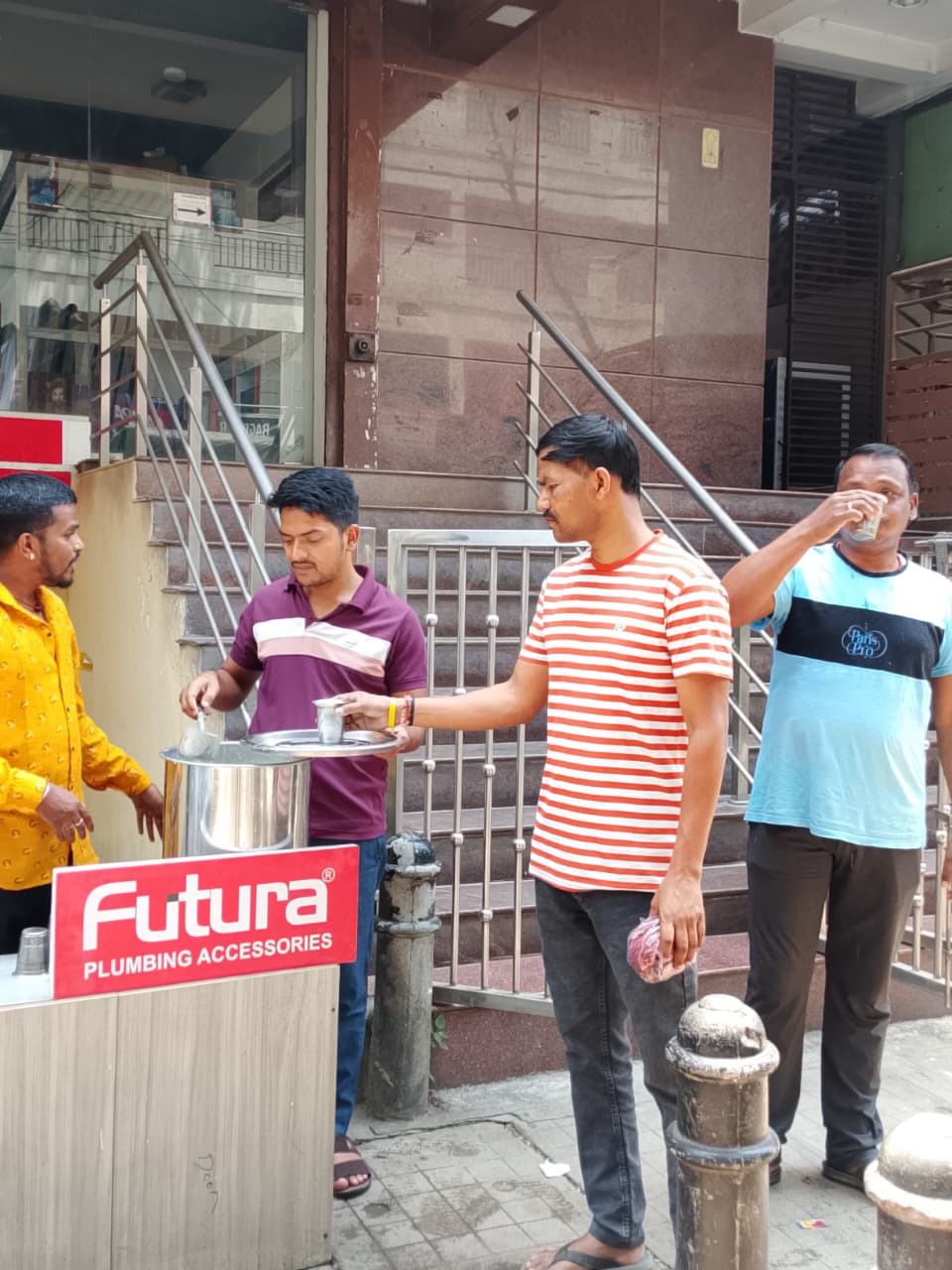 Visitors receiving free buttermilk at the Futura summer hydration campaign outside the Bengaluru office.